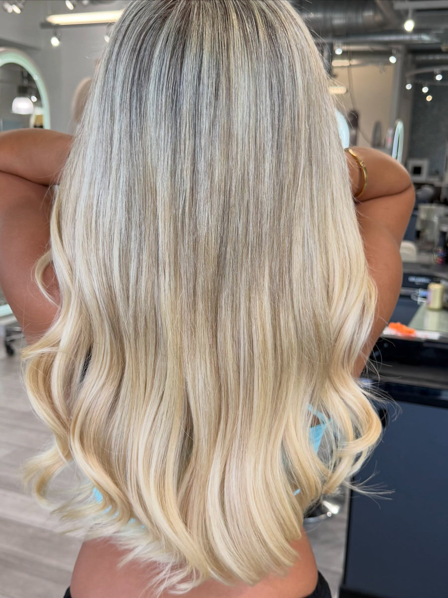 Long, blended blonde hair extensions by Natalia at Salon Sora, Boca Raton