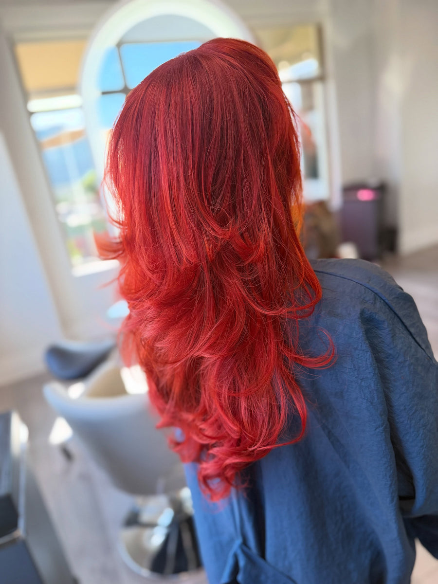 Bright red hair color with face-framing layers by Sam at Salon Sora, Boca Raton